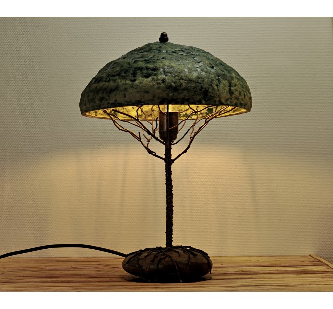 Metal table lamp with a ceramic shade and stone stand