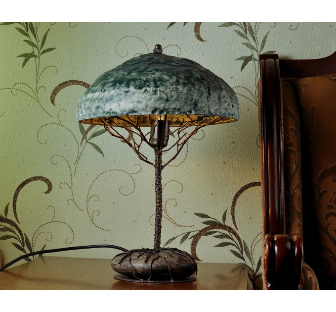 Metal table lamp with a ceramic shade and stone stand