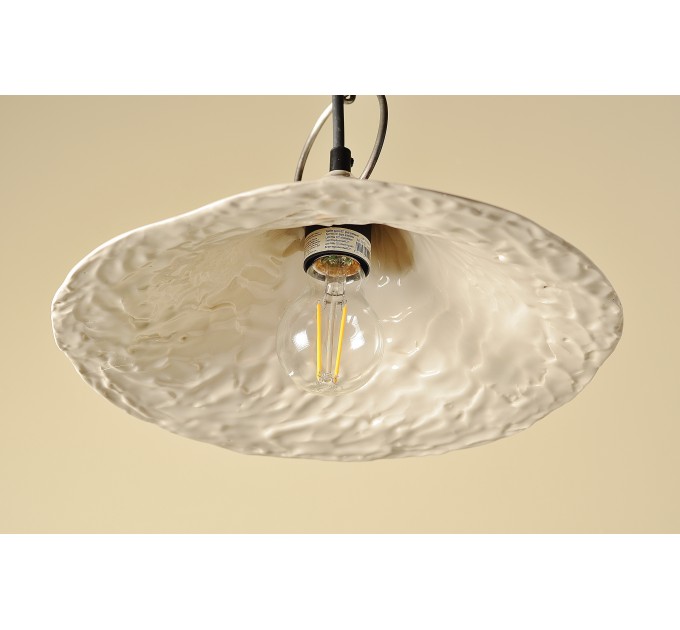 Handmade ceramic lamp in a rustic style hanging on a metal chain 
