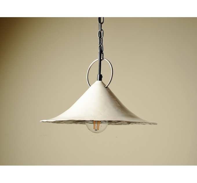 Handmade ceramic lamp in a rustic style hanging on a metal chain 