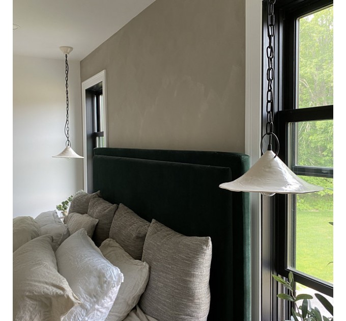 Handmade ceramic lamp in a rustic style hanging on a metal chain 