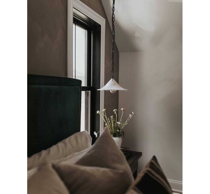Handmade ceramic lamp in a rustic style hanging on a metal chain 